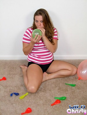 Winsome blonde teen peach Christy playing with balloons on the floor